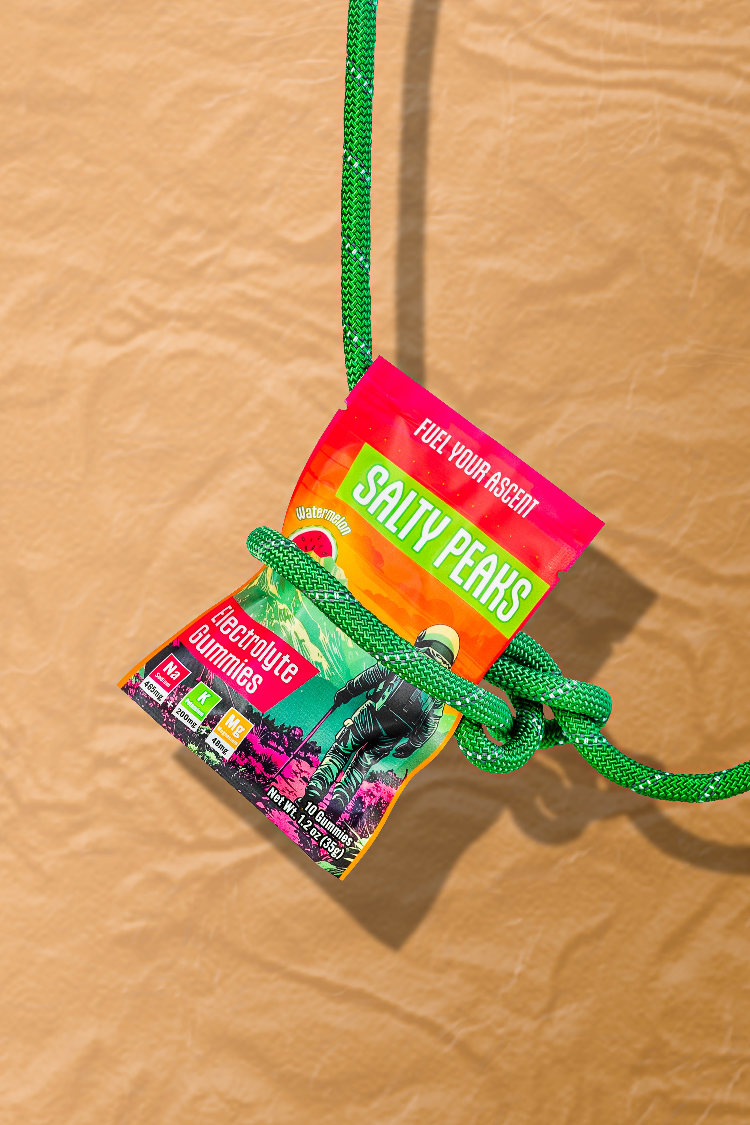 Salty Peaks single-serve packet tied to a climbing rope